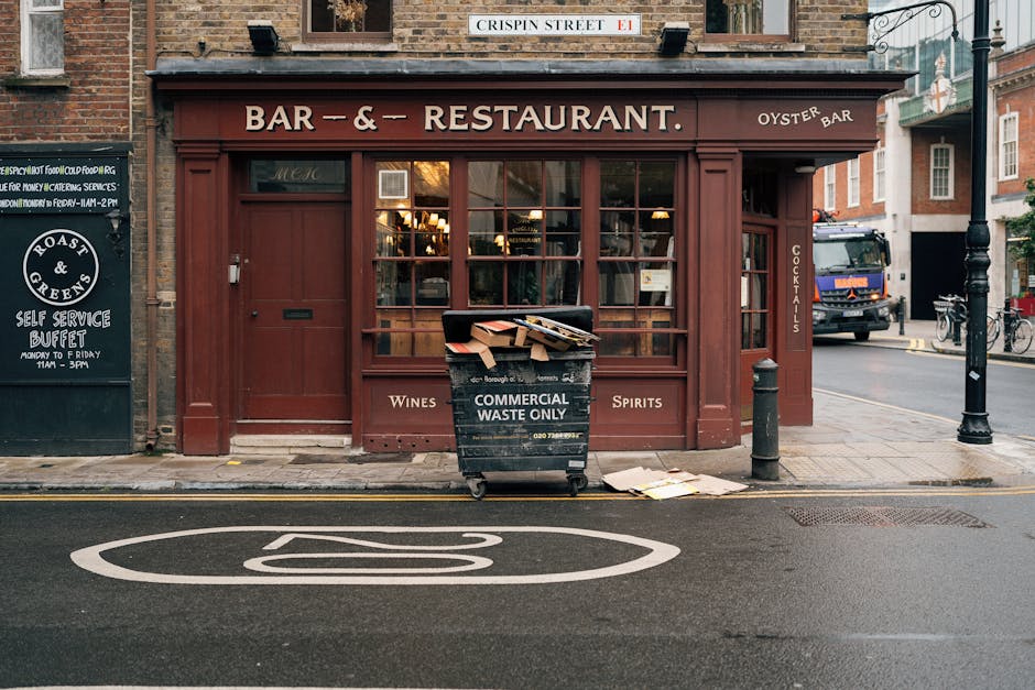 A photograph captures the upper facade of a historic building situated on Marylebone High Street, displaying signage for 'The Marylebone' pub, which advertises spirits, wines, beers, and liquors. The 